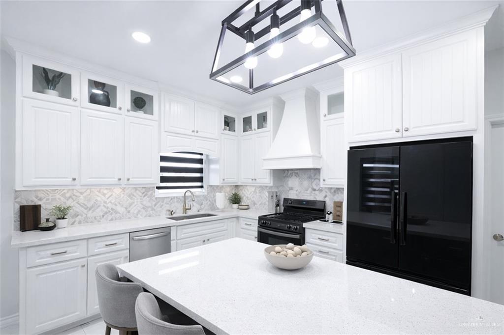325 Dawn Street Rio Grande City, TX 78582 - Photo 4 of 17 a kitchen with a sink a stove and refrigerator