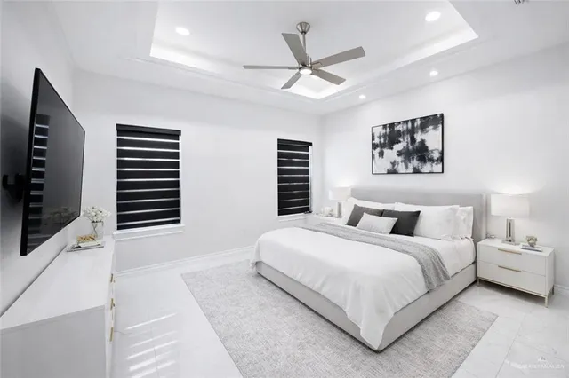 a bedroom with a large bed and a flat screen tv