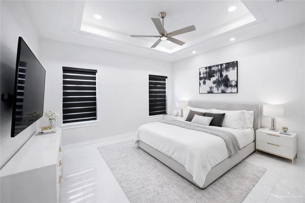 325 Dawn Street Rio Grande City, TX 78582 - Photo 7 of 17 a bedroom with a large bed and a flat screen tv