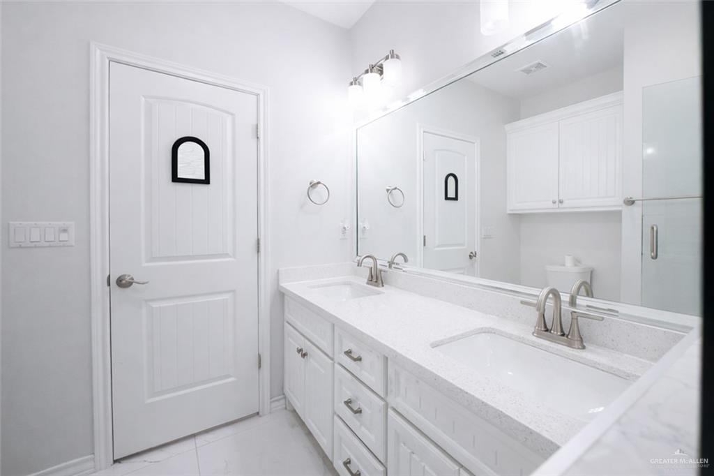 325 Dawn Street Rio Grande City, TX 78582 - Photo 8 of 17 a bathroom with double vanity sink and a mirror