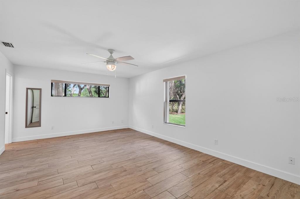 171 William Street Edgewater, FL 32141 - Photo 20 of 40 wooden floor in an empty room with a window