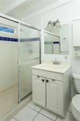 a bathroom with a sink toilet and shower