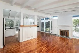 a view of a hallway with wooden floor and a fireplace