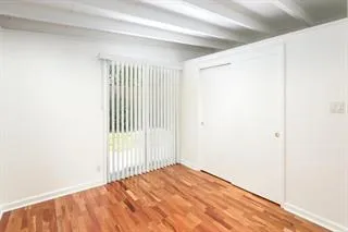 a view of a room with a wooden floor