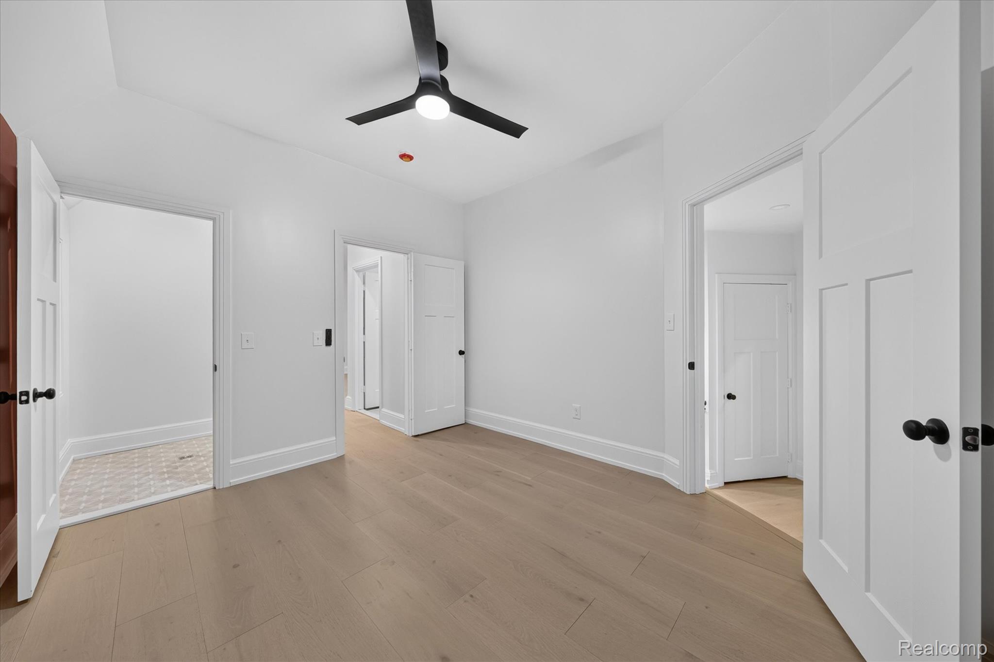 3250 Sherbourne Road Detroit, MI 48221 - Photo 23 of 36 Light wood-finish flooring, white walls, and a black ceiling fan