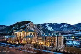 a view of a cafe with a table and chairs under an umbrella