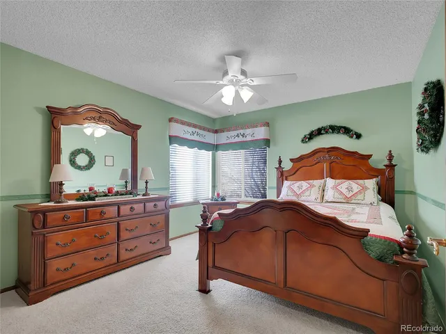 a bedroom with a bed and a dresser in it