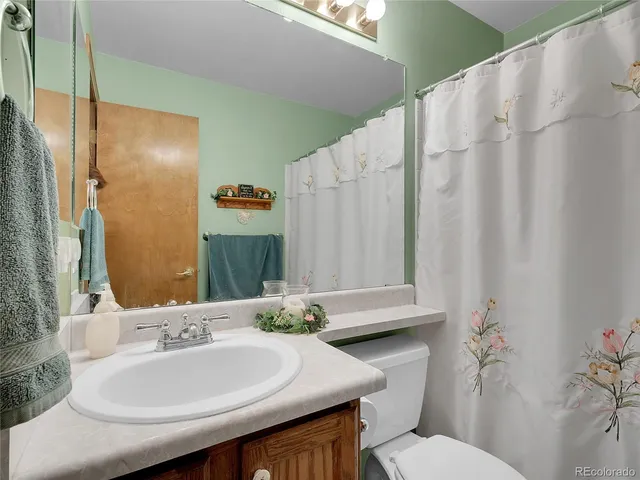 a bathroom with a sink toilet and mirror