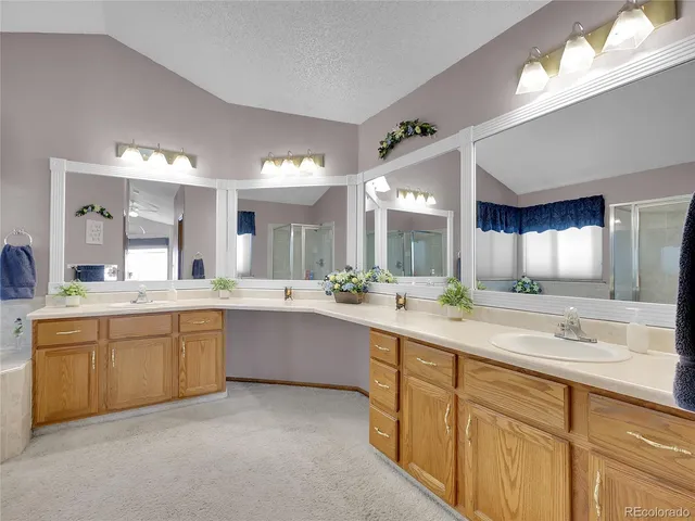 a large bathroom with a double vanity sink a mirror and a bathtub