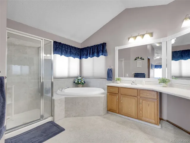 a large bathroom with a large mirror vanity and shower