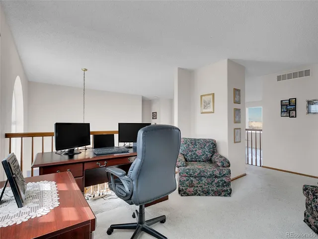 a workspace with furniture and wooden floor