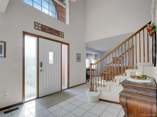 a view of a hallway with dining area and chandelier
