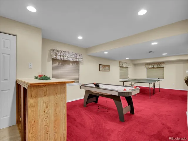 a living room with furniture pool table and a table