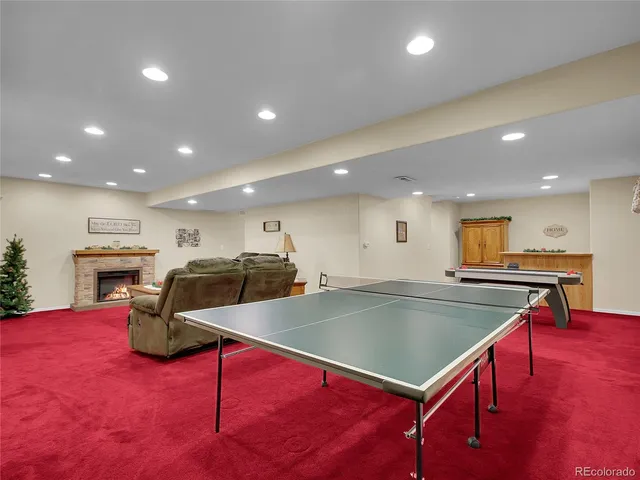 a kitchen with stainless steel appliances granite countertop a sink counter space and living room view