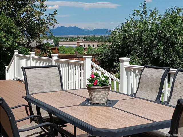 a view of a roof deck with furniture