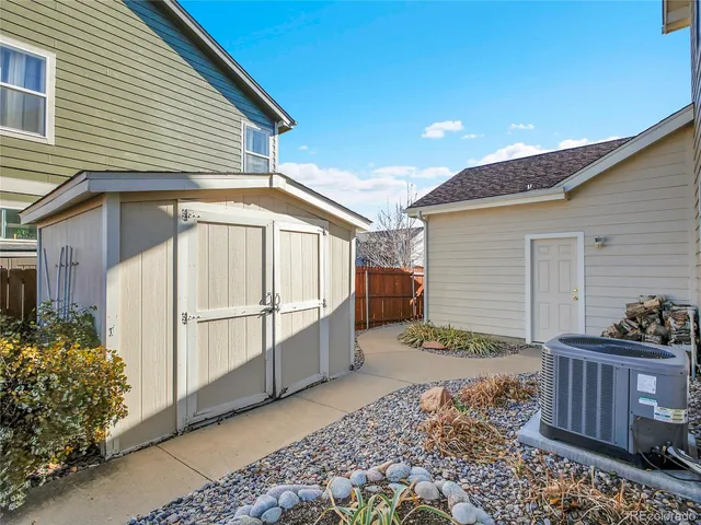 a backyard of a house with basket ball court