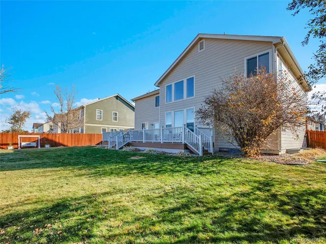 a front view of house with yard and trees