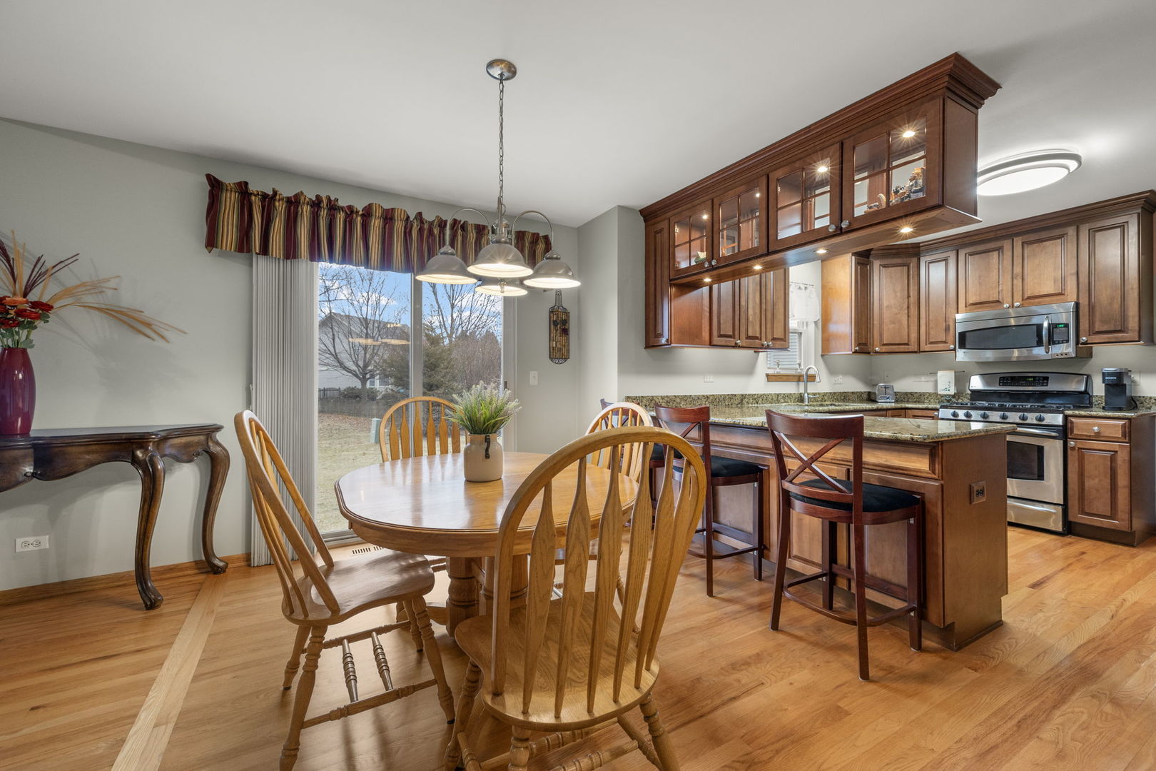 33 Forestview Lane Aurora, IL 60502 - Photo 11 of 27 a dining room with furniture a chandelier and wooden floor