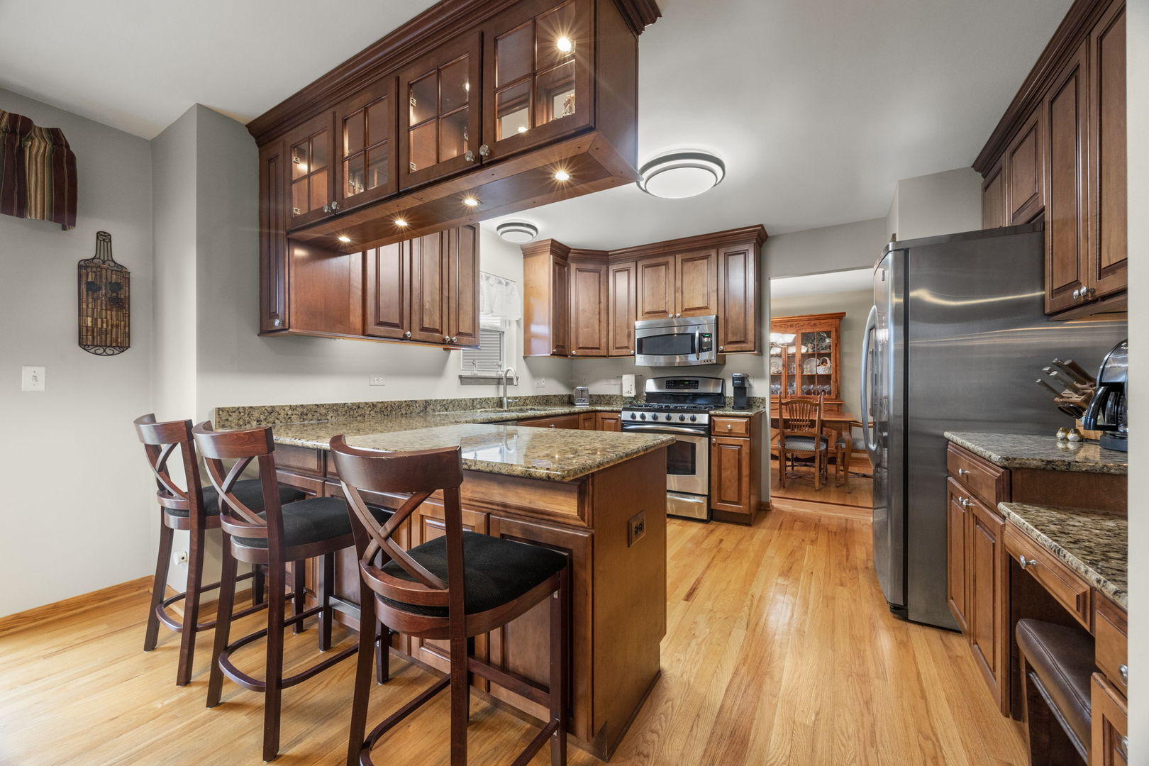 33 Forestview Lane Aurora, IL 60502 - Photo 8 of 27 a kitchen with stainless steel appliances granite countertop table chairs stove and cabinets