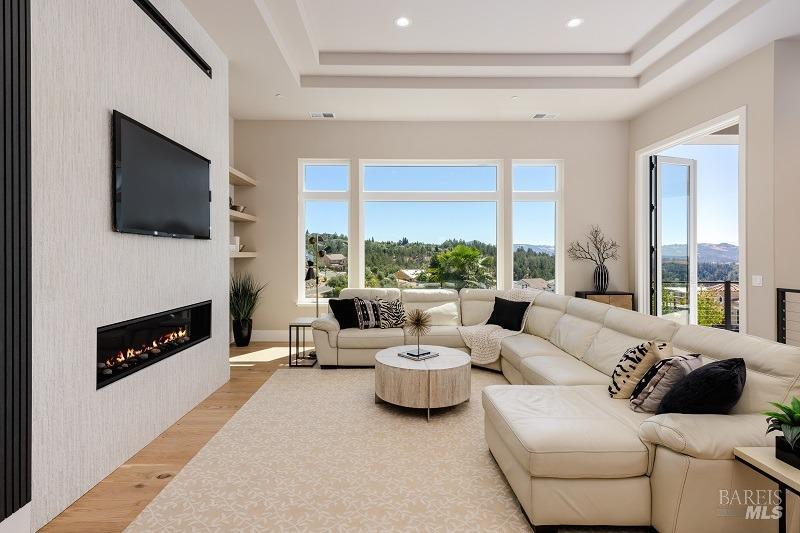 3642 Bellagio Court Santa Rosa, CA 95404 - Photo 6 of 54 The great room of your new home offers 12 ft coffered ceiling, large windows and glass door to the covered loggia with beautiful views from every room. Look at this gorgeous linear fireplace with floor to ceiling tile.