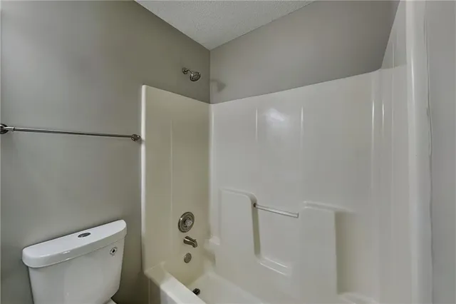 a bathroom with a bathtub and a toilet