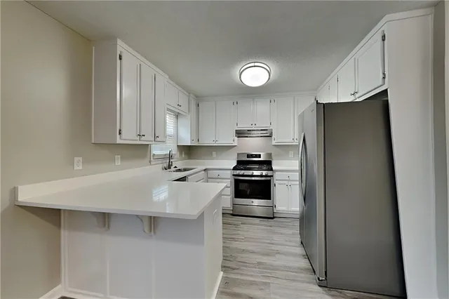 a kitchen with stainless steel appliances a refrigerator stove and sink
