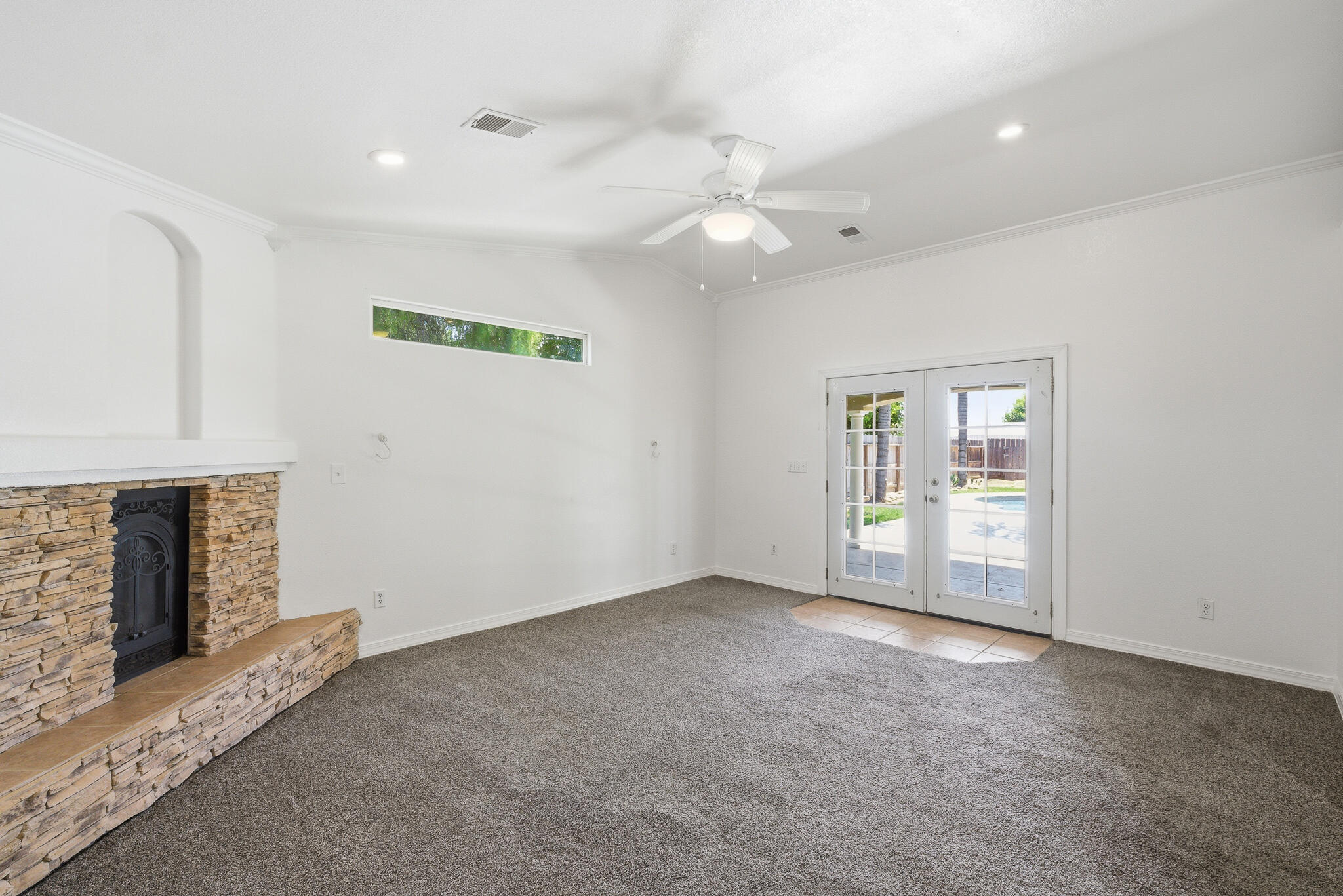 618 Birdsong Court Exeter, CA 93221 - Photo 41 of 62 an empty room with windows and fireplace