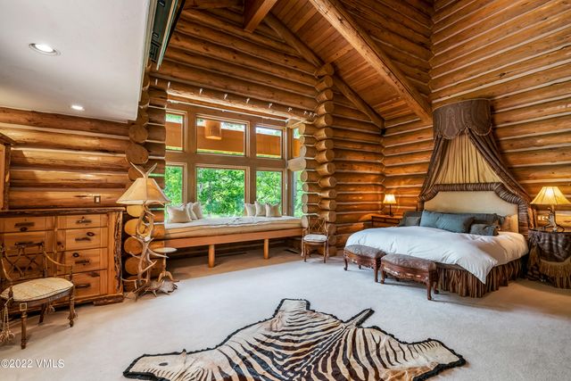 a dining room with furniture a chandelier and wooden floor