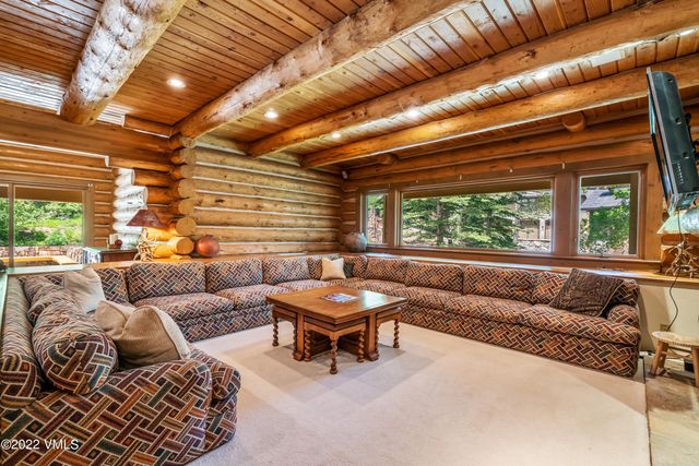 a outdoor dining space with furniture and flat screen tv