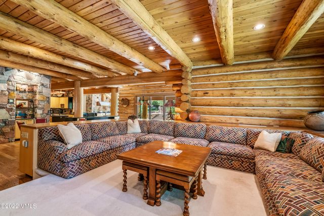 a view of a living room with furniture and a kitchen view