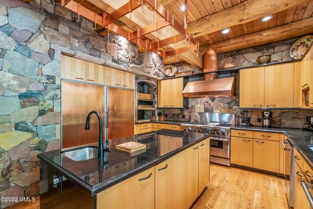 a bedroom with a bed a flat screen tv and next to a window