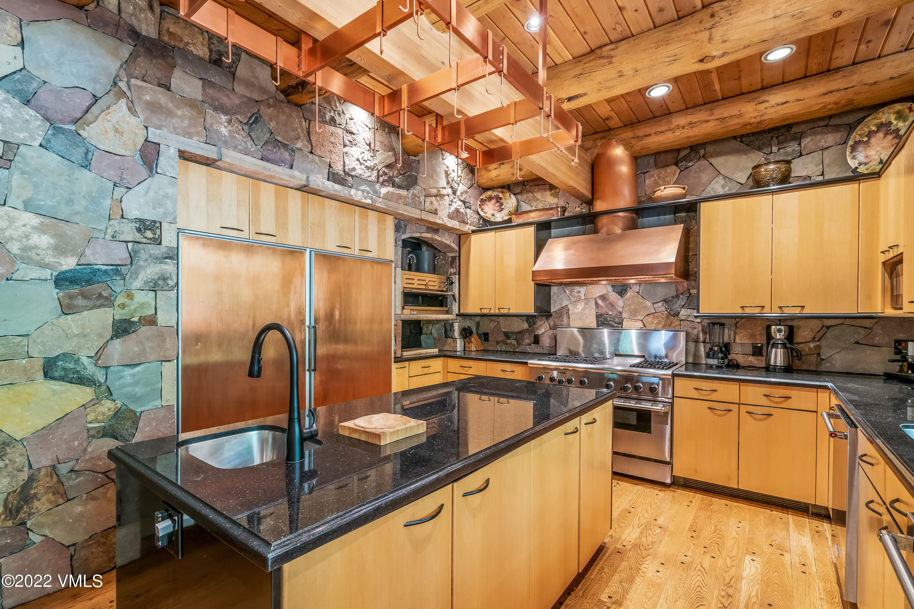 447 Borders Road Beaver Creek, CO 81620 - Photo 32 of 71 a kitchen with stainless steel appliances granite countertop a sink window and refrigerator