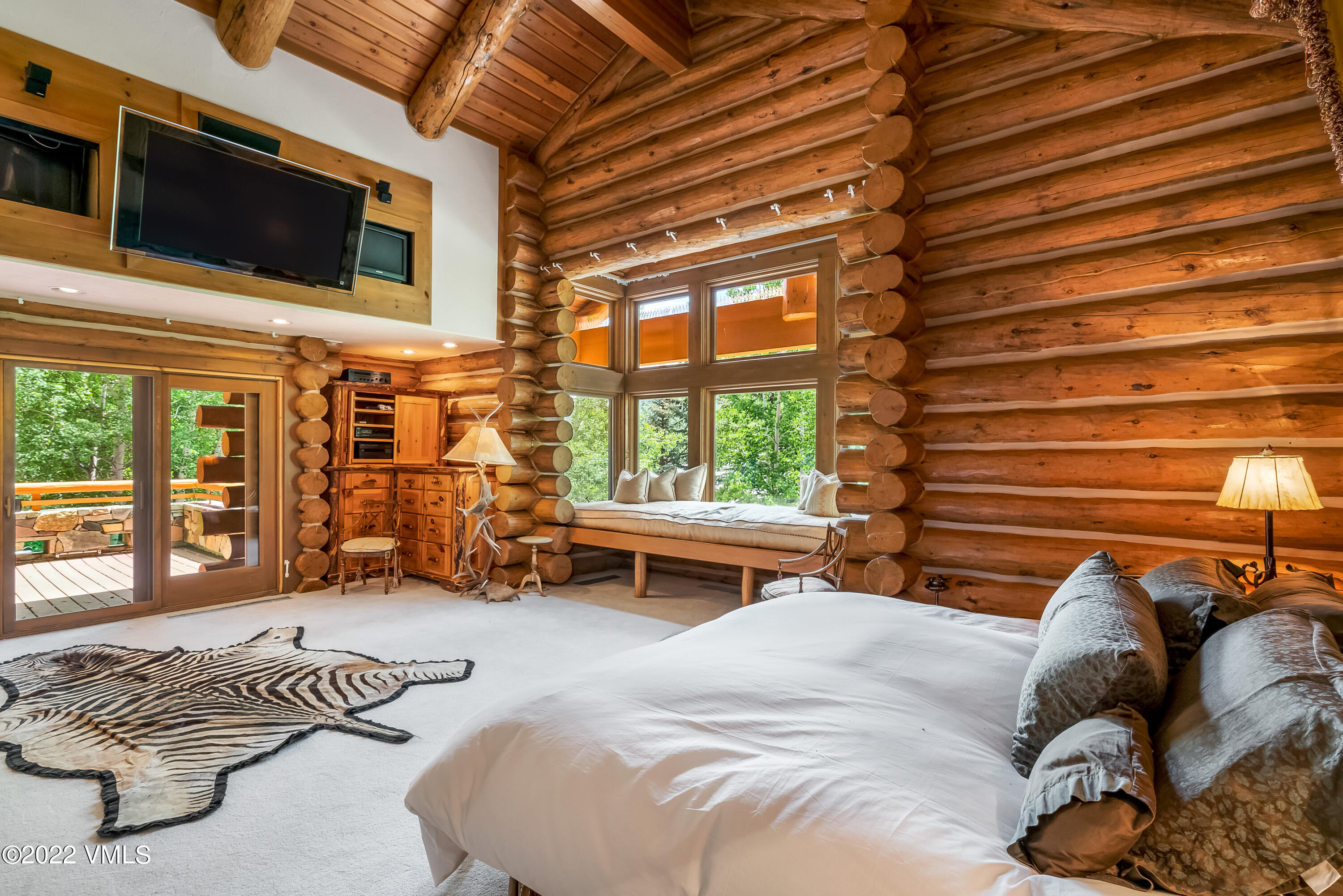 447 Borders Road Beaver Creek, CO 81620 - Photo 42 of 71 a bedroom with a bed a flat screen tv and next to a window