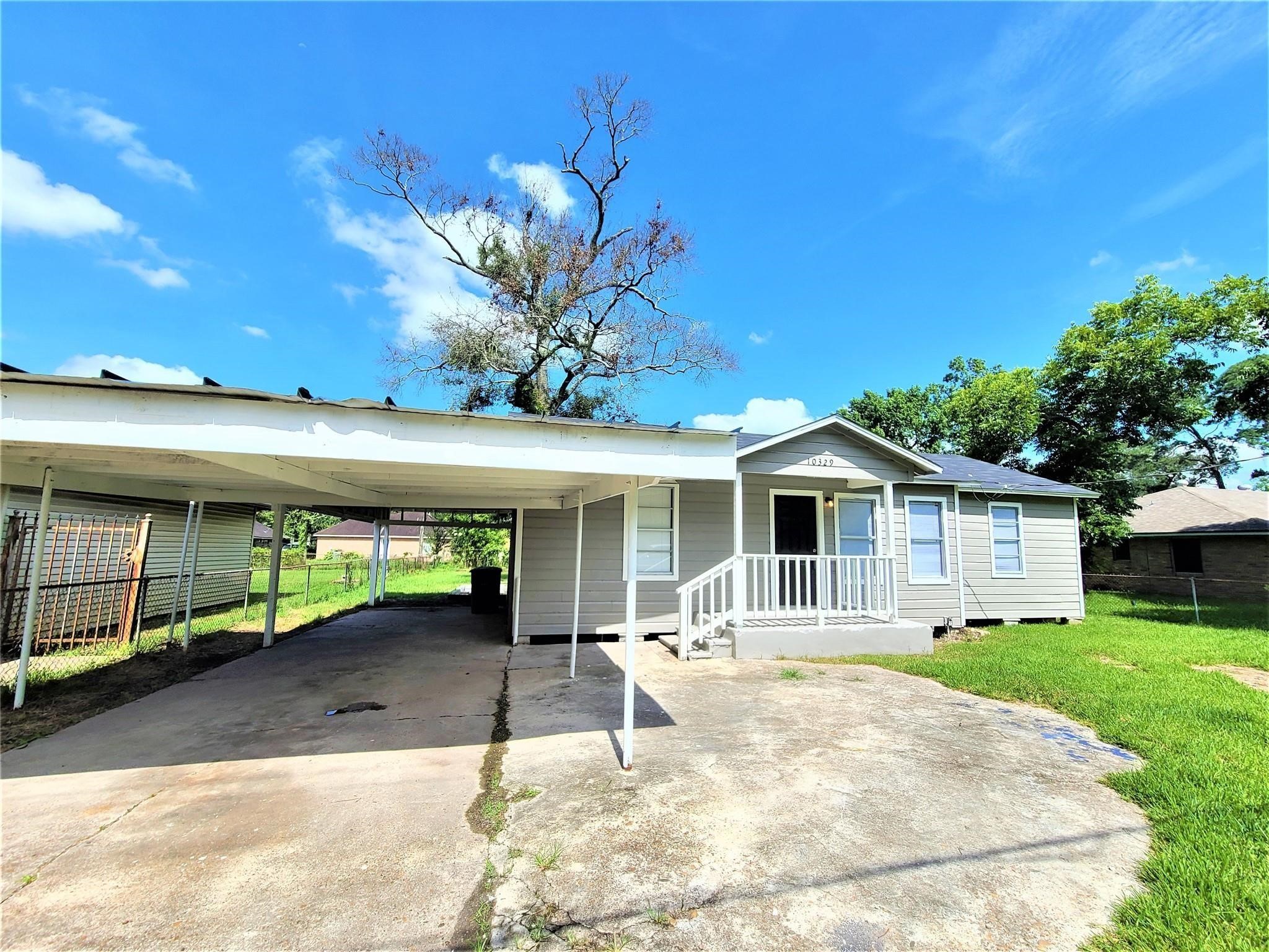 a backyard of a house with yard and outdoor seating