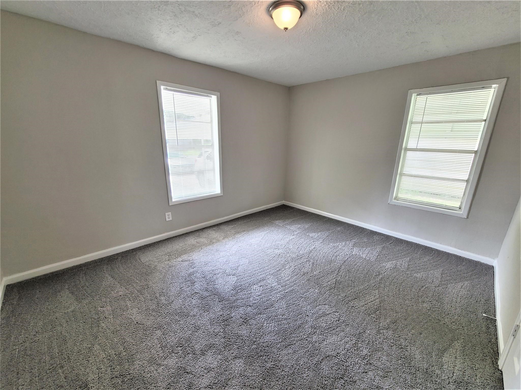 10329 Wicklowe Street Houston, TX 77016 - Photo 5 of 10 an empty room with windows