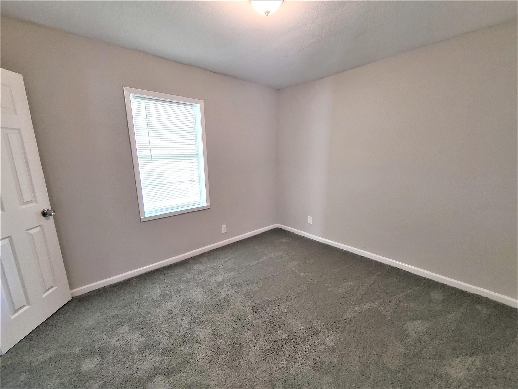 10329 Wicklowe Street Houston, TX 77016 - Photo 8 of 10 an empty room with a window