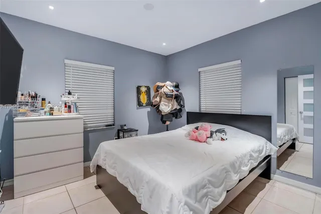 a bedroom with a bed and dresser