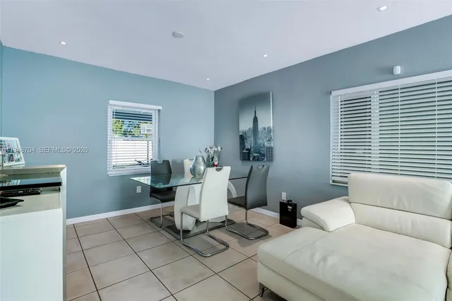 a living room with furniture a window and a table