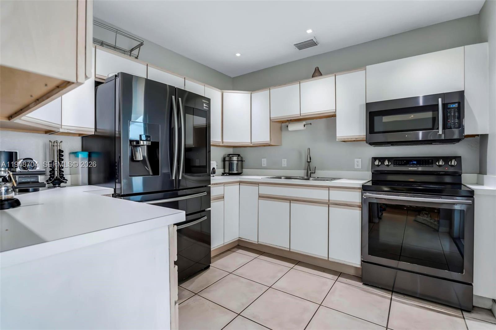 14860 Buchanan Street Miami, FL 33176 - Photo 8 of 27 a kitchen with stainless steel appliances a stove sink microwave and cabinets