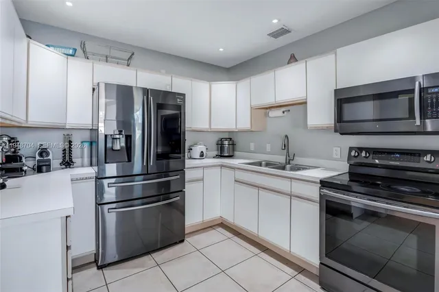 a kitchen with stainless steel appliances and cabinets