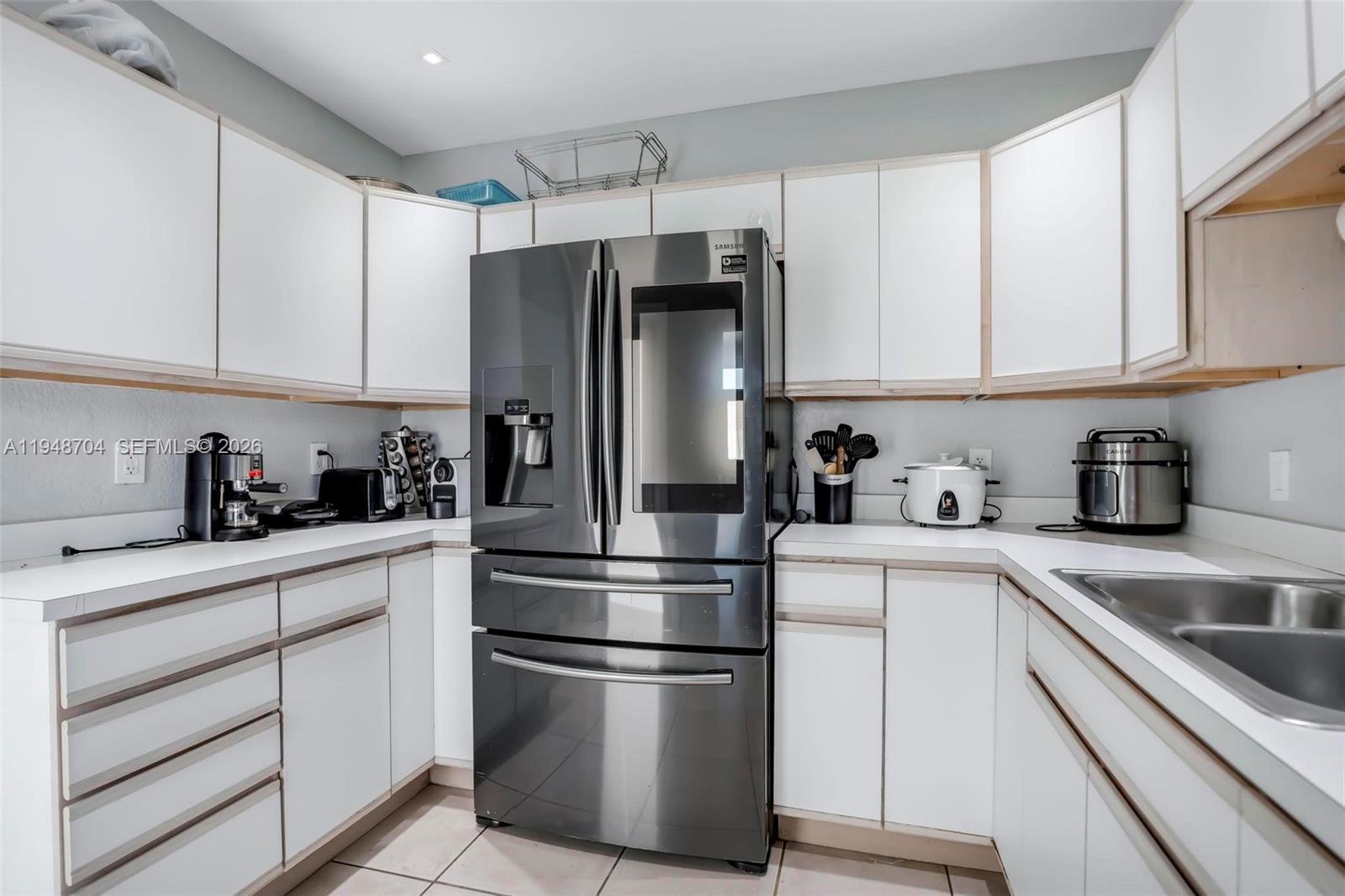 14860 Buchanan Street Miami, FL 33176 - Photo 10 of 27 a kitchen with cabinets stainless steel appliances and a window