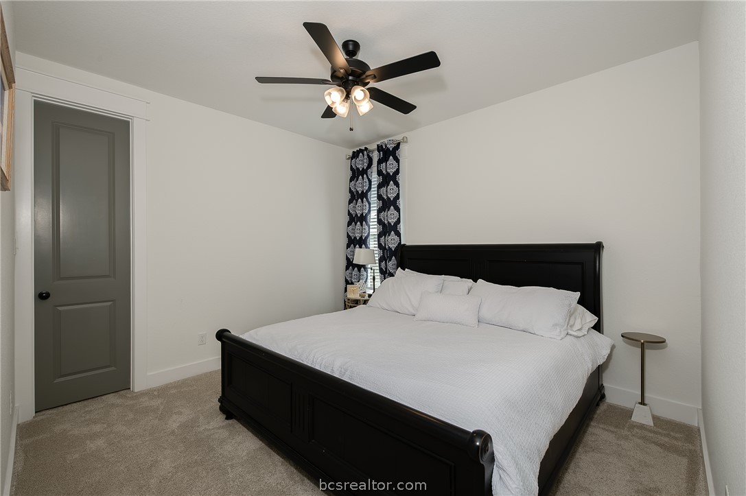 3317 Stone Leigh Lane Bryan, TX 77808 - Photo 19 of 30 a bedroom with a bed and a table