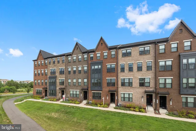 a front view of a building with a yard
