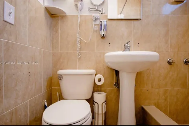 a white toilet sitting next to a bathroom sink