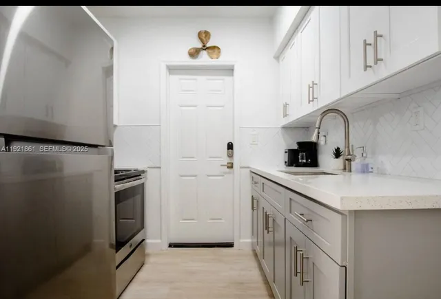 a kitchen with a sink and a refrigerator