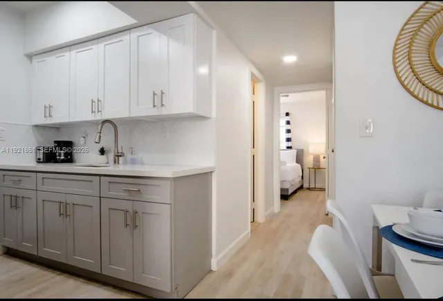 a kitchen with a sink and a toilet