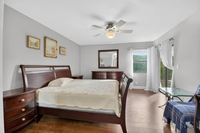 a bedroom with a bed a chandelier and a window