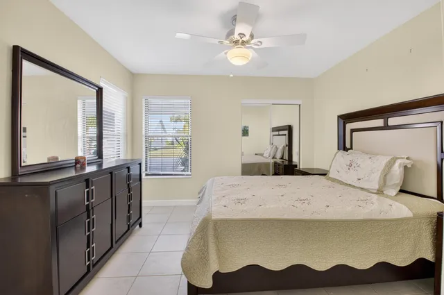 a spacious bedroom with a large bed and a chandelier