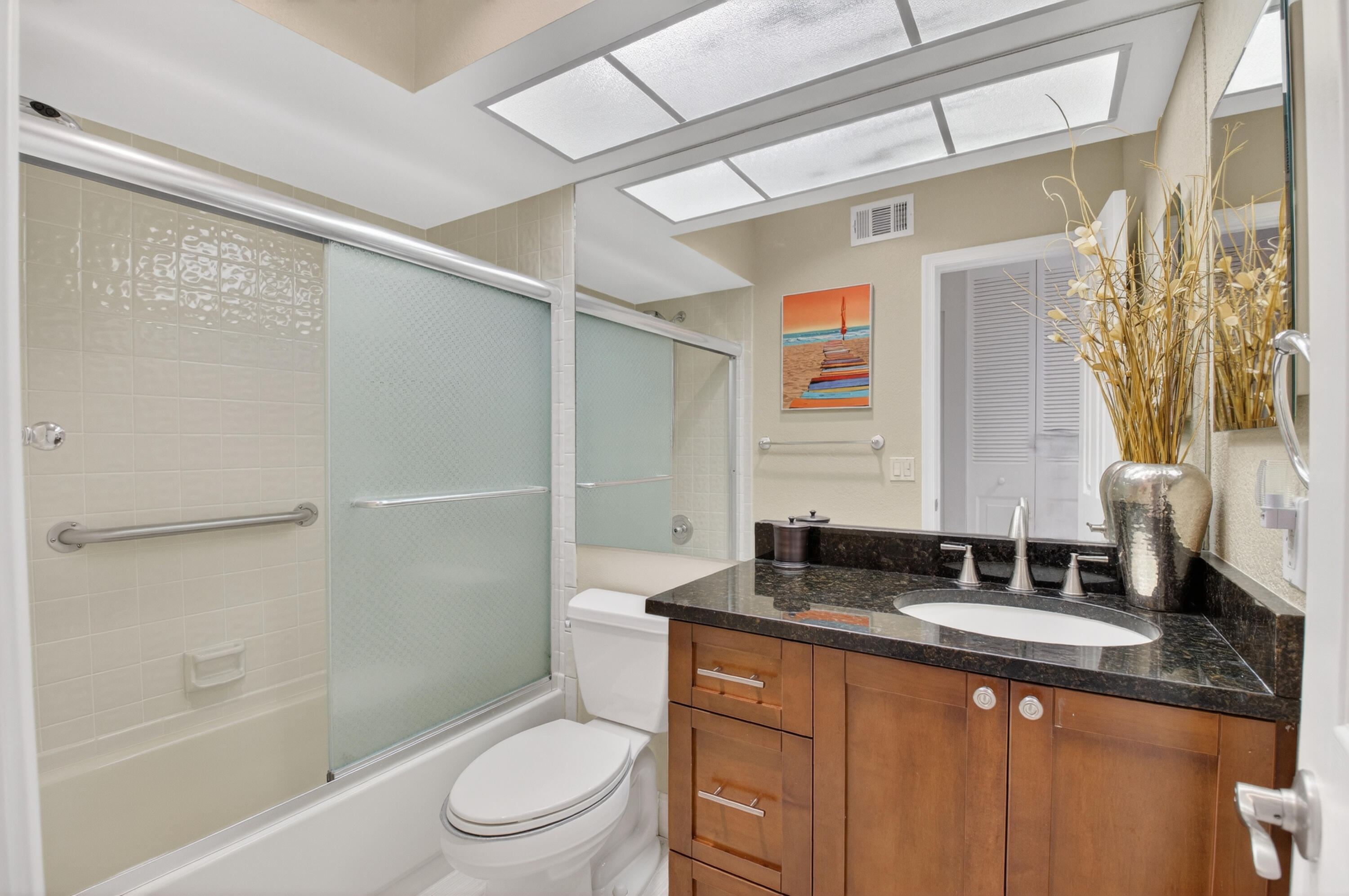 10980 Hidden Lake Place Boca Raton, FL 33498 - Photo 20 of 44 a bathroom with a granite countertop sink toilet and shower