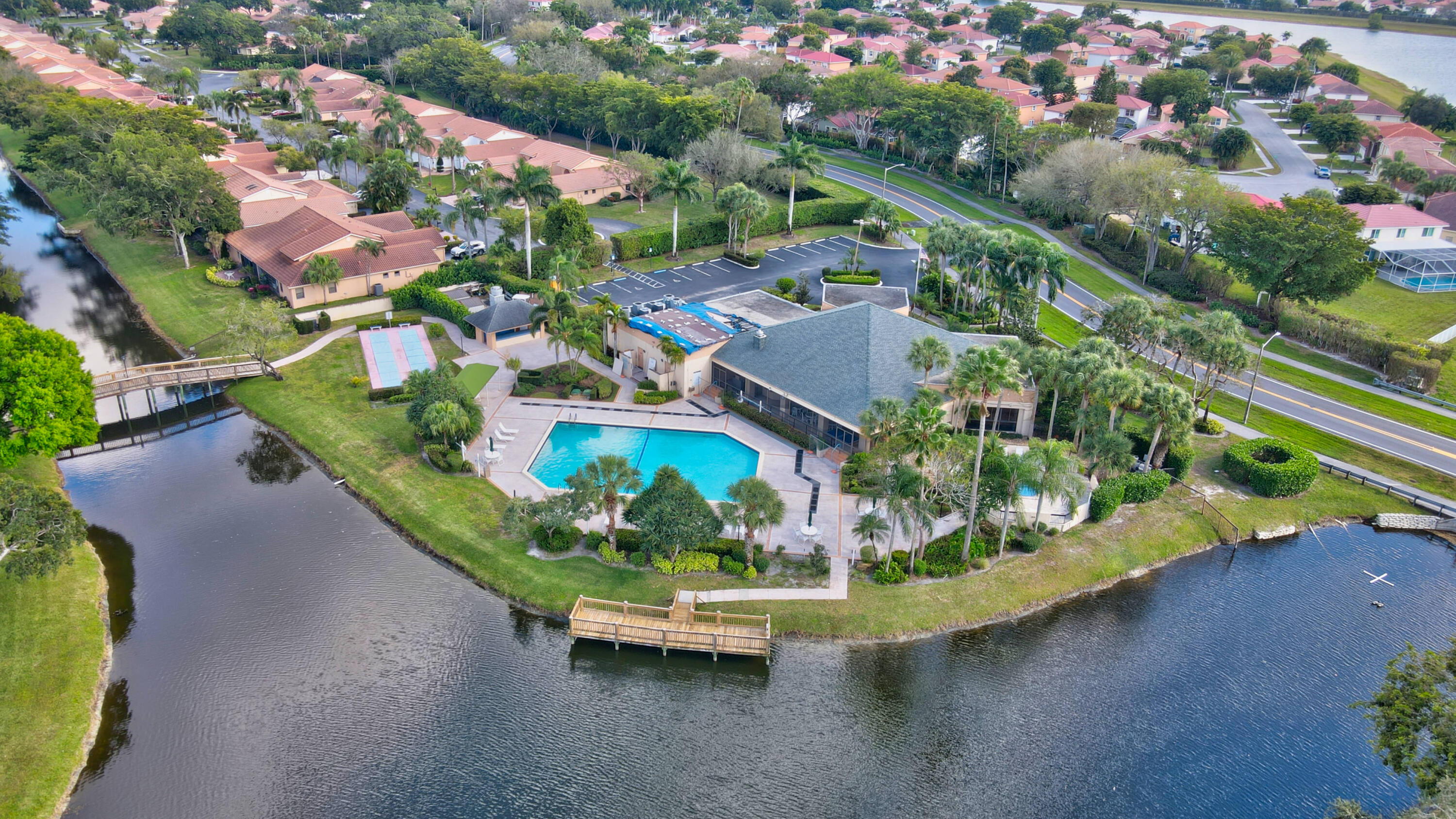 10980 Hidden Lake Place Boca Raton, FL 33498 - Photo 28 of 44 an aerial view of a house with a garden and lake view